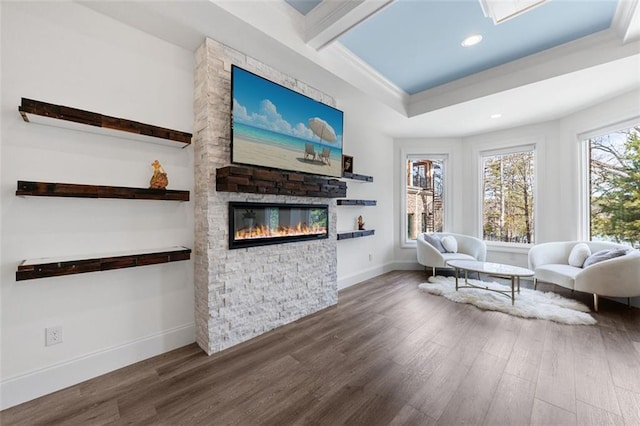 living area with a fireplace, baseboards, wood finished floors, and recessed lighting