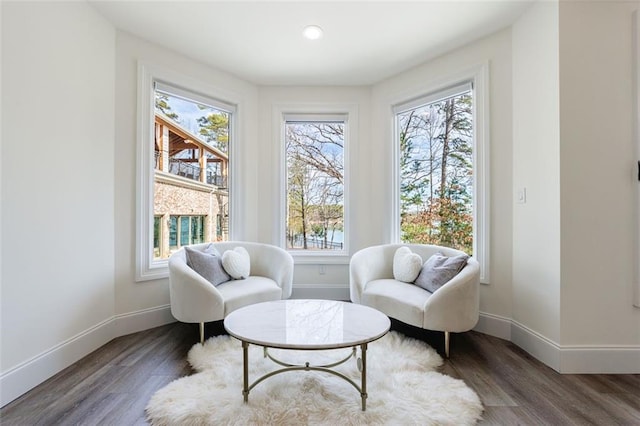 sitting room with wood finished floors and baseboards