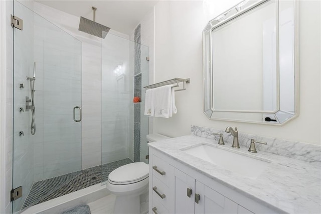 bathroom featuring a stall shower, vanity, and toilet