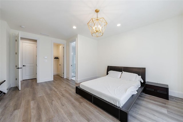 bedroom with a notable chandelier, recessed lighting, light wood-style flooring, and baseboards