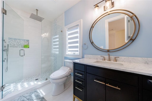 full bathroom featuring vanity, a shower stall, and toilet