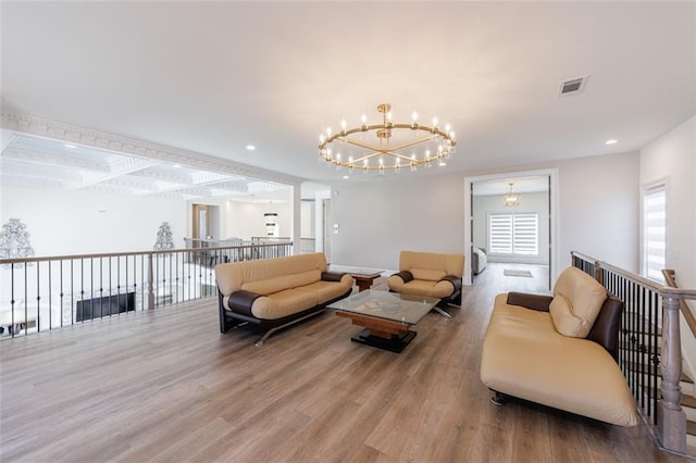 living area with recessed lighting, wood finished floors, visible vents, and a notable chandelier