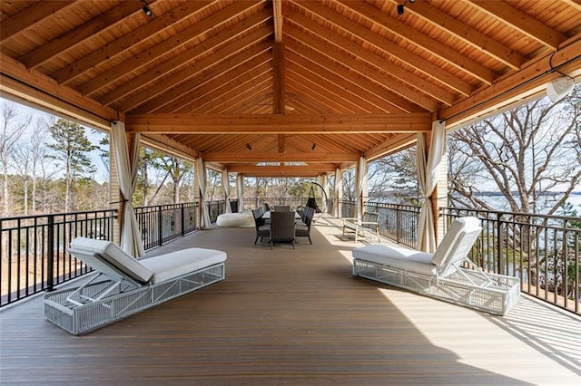 deck featuring outdoor dining area and a gazebo