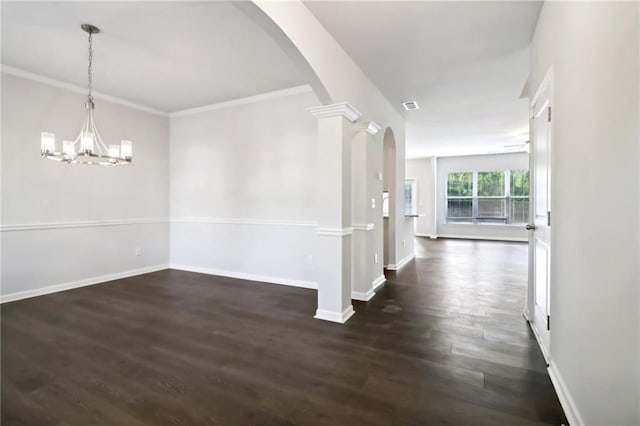 interior space featuring a notable chandelier, ornamental molding, dark wood-type flooring, and decorative columns