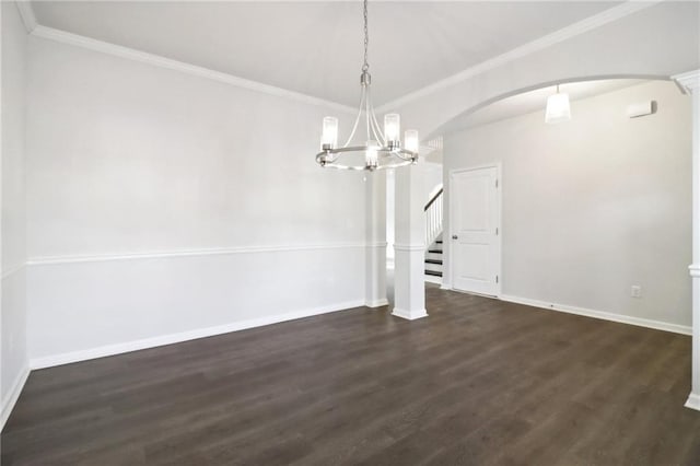 unfurnished dining area featuring dark hardwood / wood-style flooring, an inviting chandelier, and ornamental molding