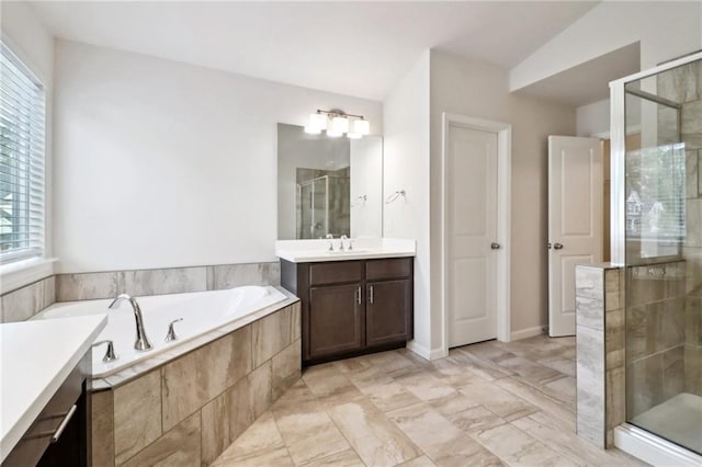 bathroom featuring vanity, lofted ceiling, and shower with separate bathtub