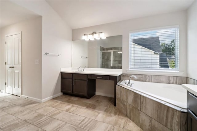 bathroom featuring vanity and independent shower and bath