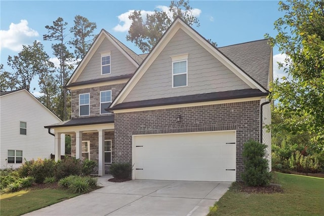 craftsman-style house with a garage and a front lawn