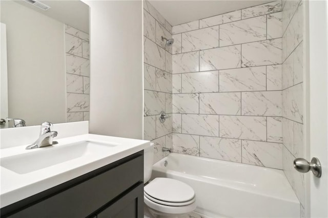 full bathroom with vanity, tiled shower / bath combo, and toilet