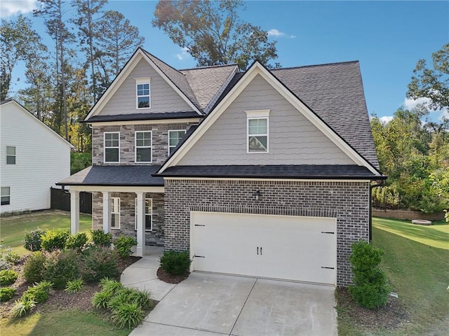 craftsman-style house featuring a garage and a front lawn