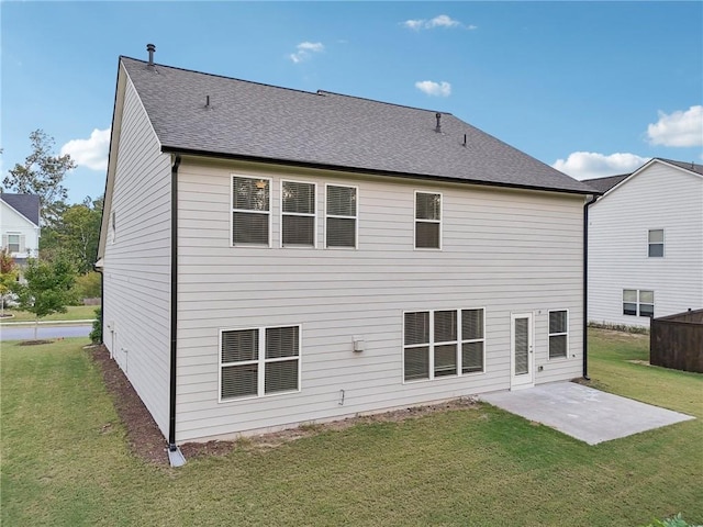 rear view of house featuring a patio and a lawn