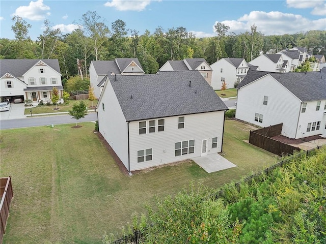 back of property with a yard and a patio