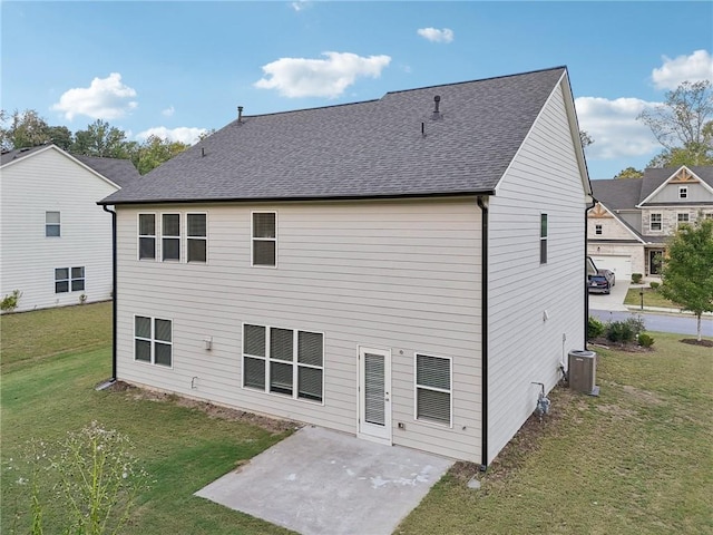 back of property featuring central air condition unit, a patio area, and a yard