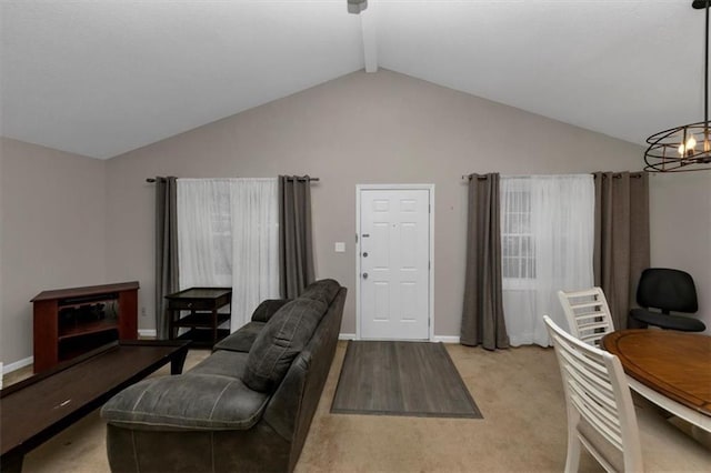 living room with vaulted ceiling with beams and a chandelier