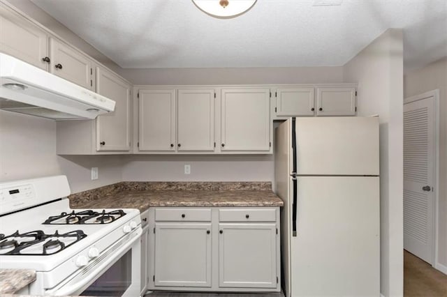 kitchen featuring white cabinetry and white appliances