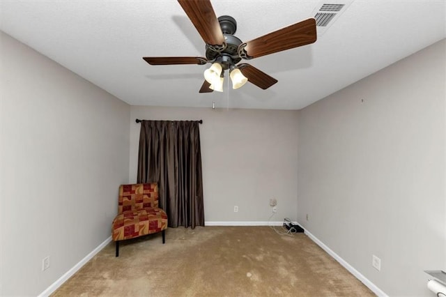 unfurnished room with light colored carpet and ceiling fan