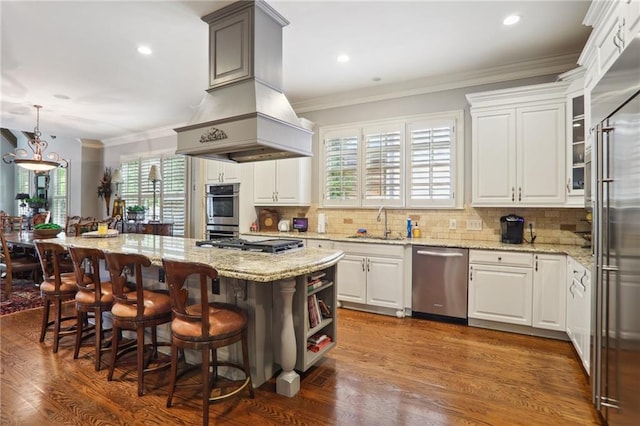 kitchen featuring a wealth of natural light, white cabinetry, appliances with stainless steel finishes, and a center island