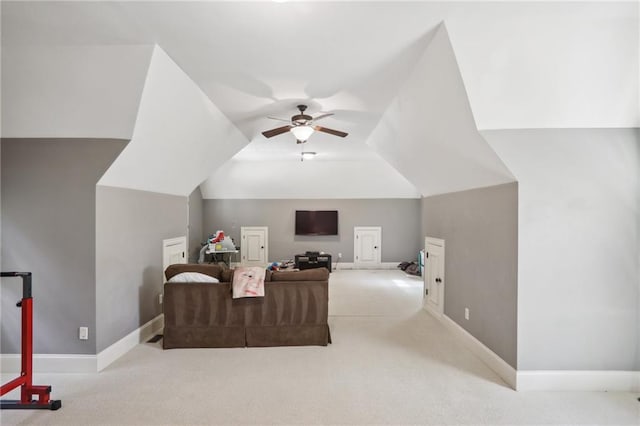 interior space featuring ceiling fan, light colored carpet, and vaulted ceiling