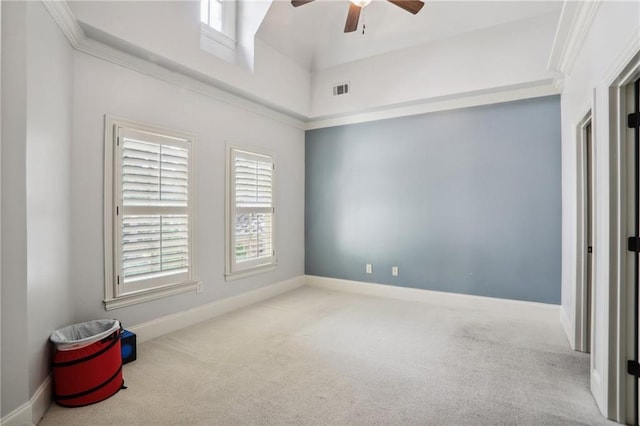 spare room with crown molding, ceiling fan, and light carpet