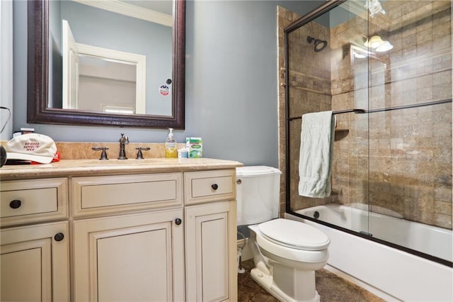 full bathroom featuring shower / bath combination with glass door, ornamental molding, vanity, and toilet