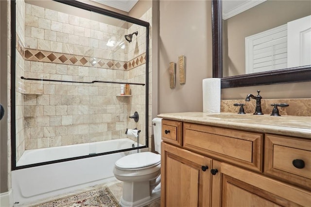 full bathroom featuring crown molding, shower / bath combination with glass door, vanity, and toilet