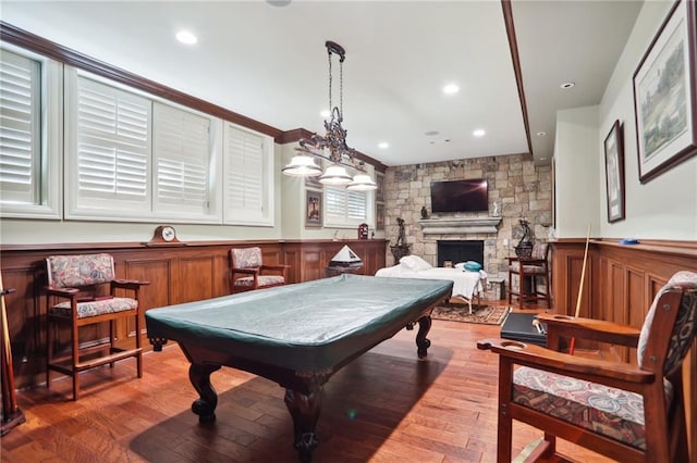 rec room with a fireplace and hardwood / wood-style floors