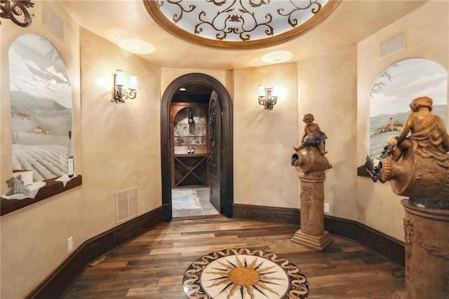 interior space featuring hardwood / wood-style flooring and a tray ceiling