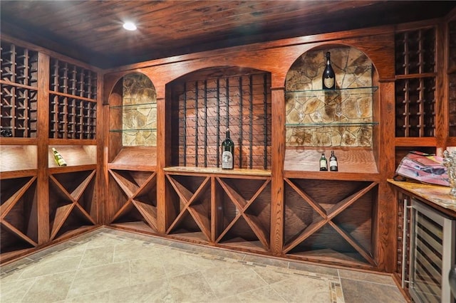 wine cellar with wine cooler and wood ceiling