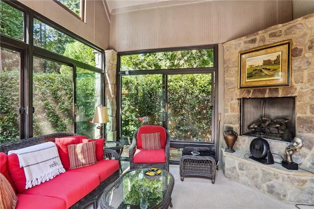 sunroom / solarium with a stone fireplace