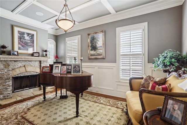 miscellaneous room featuring a stone fireplace, coffered ceiling, light hardwood / wood-style flooring, and a wealth of natural light