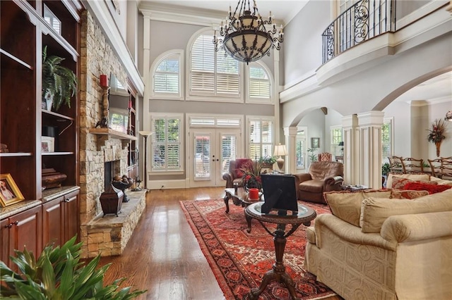 living room featuring hardwood / wood-style floors, a high ceiling, and a healthy amount of sunlight