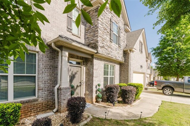 3241 Alhambra Cir, Hampton, GA 30228 - view of exterior entry with a garage and brick siding