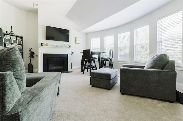 3241 Alhambra Cir, Hampton, GA 30228 - carpeted living area featuring baseboards, a fireplace with flush hearth, plenty of natural light, and lofted ceiling