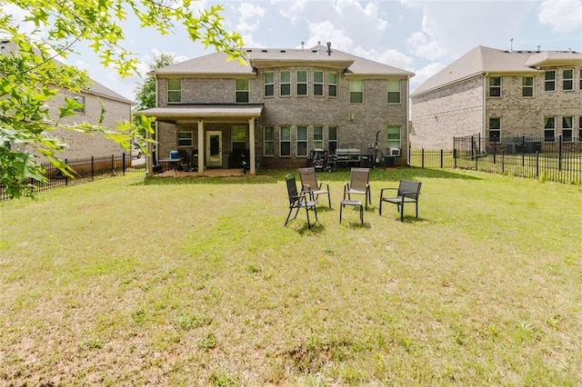 3241 Alhambra Cir, Hampton, GA 30228 - rear view of property with a lawn, a fenced backyard, and brick siding