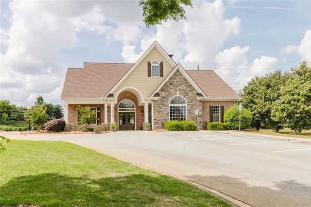 3241 Alhambra Cir, Hampton, GA 30228 - craftsman-style house featuring french doors, uncovered parking, a front lawn, and stone siding