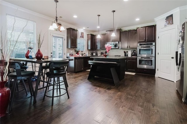 3241 Alhambra Cir, Hampton, GA 30228 - kitchen featuring dark wood-type flooring, ornamental molding, dark brown cabinets, and stainless steel appliances