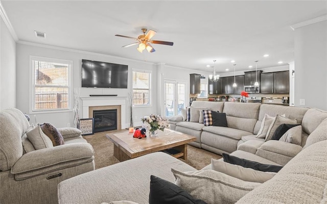 living room featuring crown molding and ceiling fan