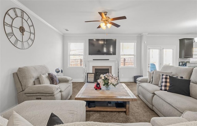 carpeted living room with ceiling fan and ornamental molding