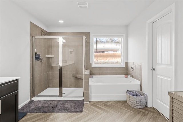 bathroom with independent shower and bath, vanity, and parquet flooring