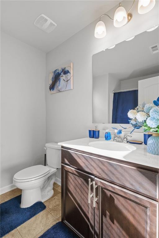 bathroom featuring tile patterned flooring, vanity, and toilet