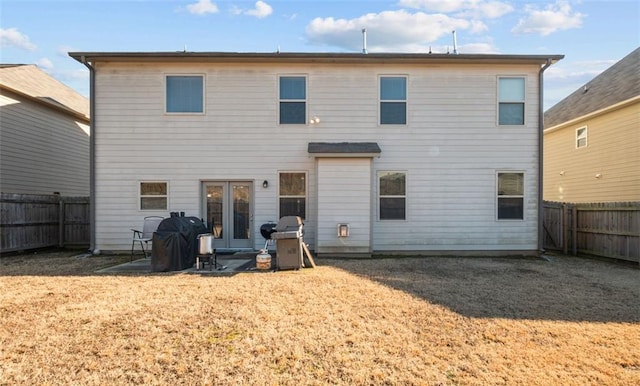 back of property with a patio area and a lawn