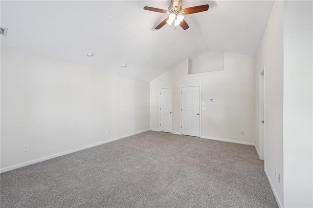carpeted spare room featuring ceiling fan, vaulted ceiling, baseboards, and visible vents