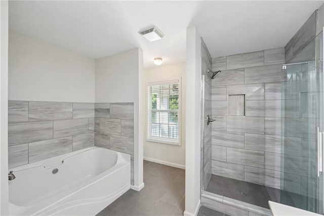 bathroom with a bath, visible vents, a shower stall, tile patterned floors, and baseboards