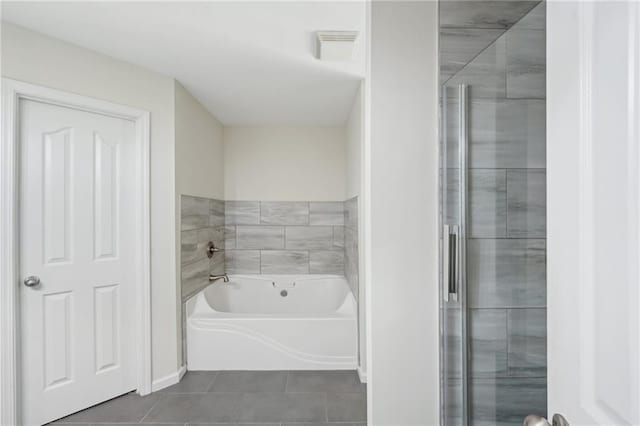 full bathroom featuring tile patterned flooring and a garden tub