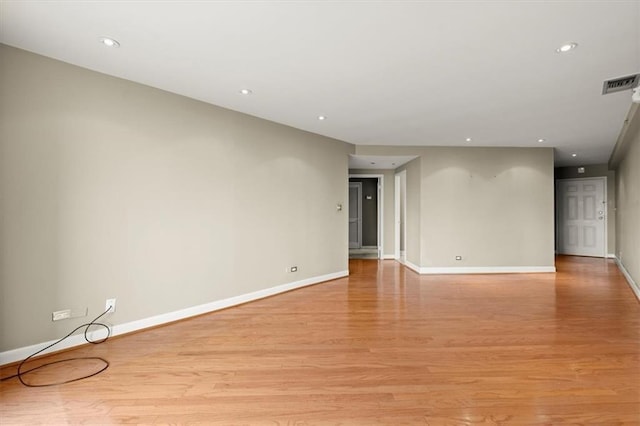 empty room with light wood-style flooring, recessed lighting, visible vents, and baseboards