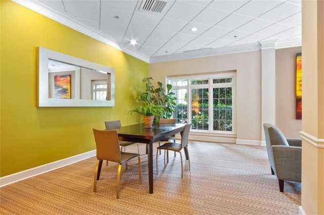 dining room featuring baseboards, carpet, visible vents, and crown molding