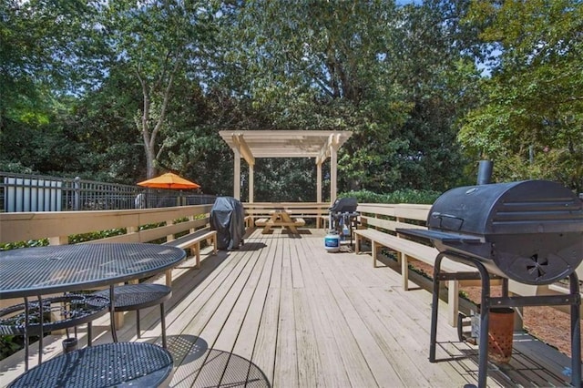 wooden deck featuring a grill and outdoor dining space