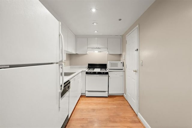 kitchen featuring light wood finished floors, light countertops, white cabinetry, white appliances, and under cabinet range hood