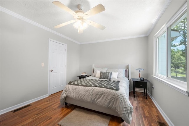 bedroom with wood finished floors, baseboards, ornamental molding, and a ceiling fan