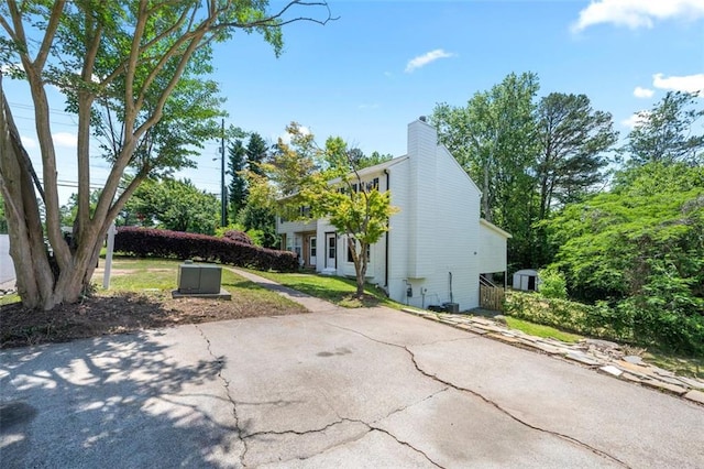 view of home's exterior with a chimney and a patio